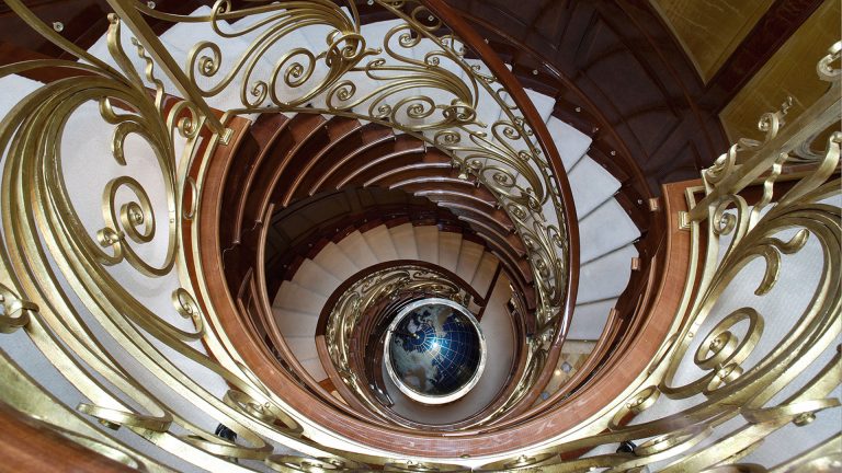 Spiral staircase connecting decks with a fabulous globe sculpture, designed by David Harbour, in 24 carat gold. The globe is used as a drinks cabinet.